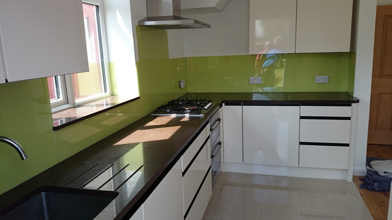 Lime green glass kitchen splashback installed by Nine Elms glaziers