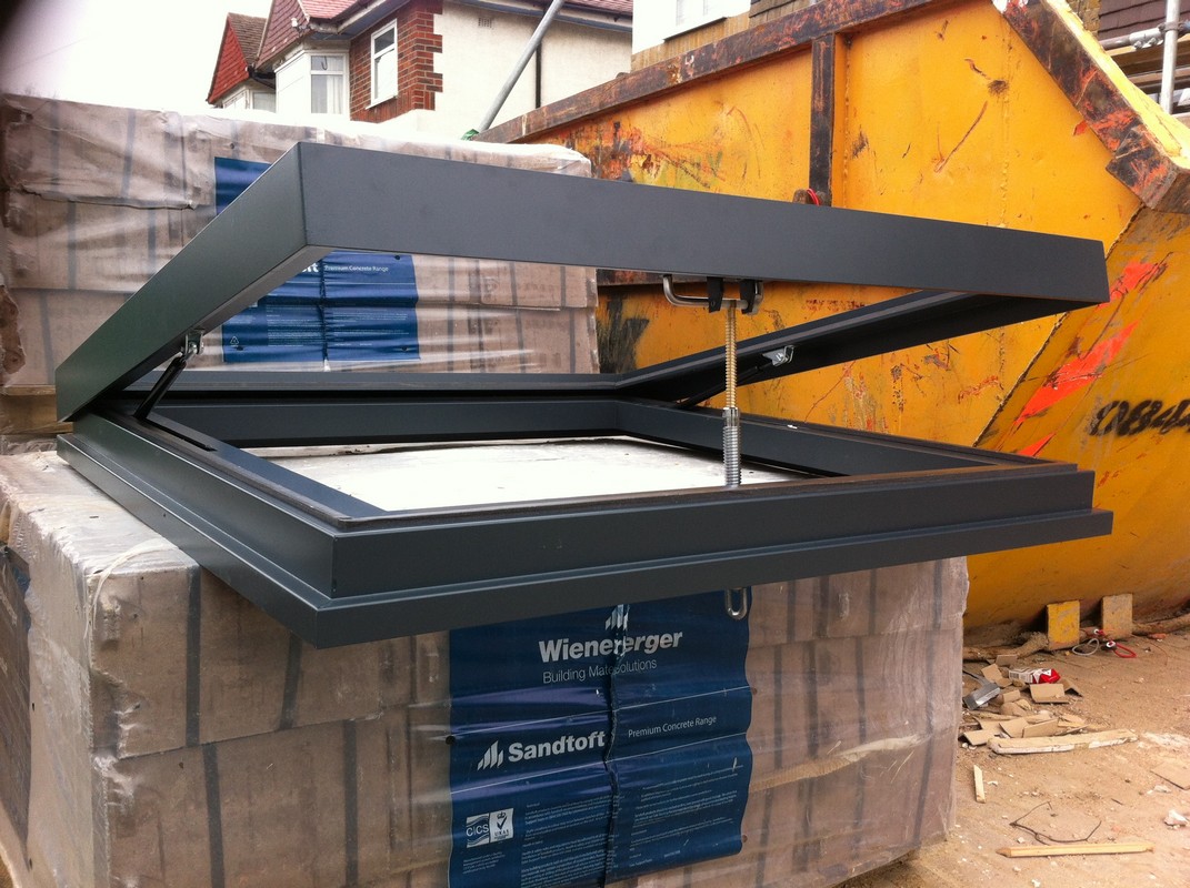 Opening flat roof skylight in anthracite grey installed in Nine Elms