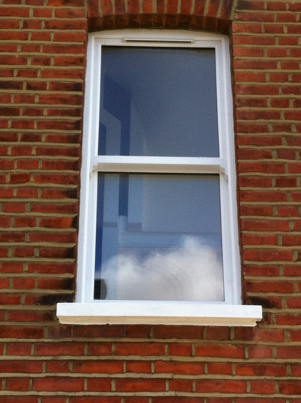 uPVC sash window on Victorian red brick house in Nine Elms